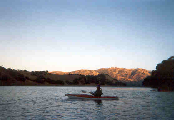 Kayaking as the sun sets on DeValle Reservoir in Livermore, Californina