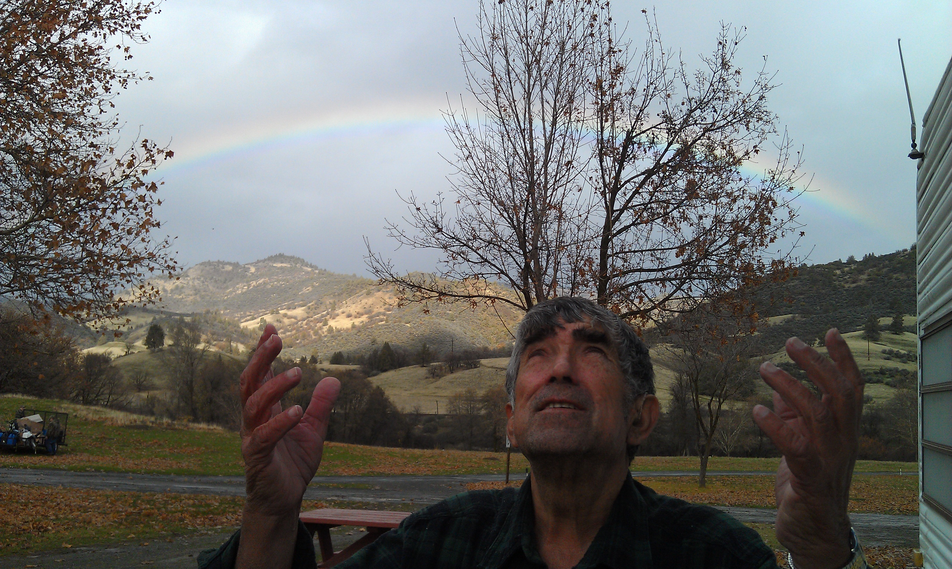 Woody excitedly remembering again God's goodness with a rainbow in the background!
